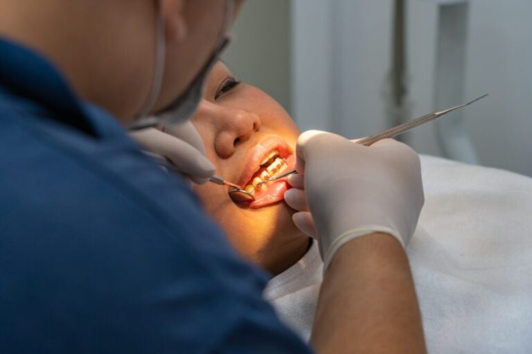 Dentist checking patient gums for signs of gum disease at Reston Serenity Smiles in Reston, VA