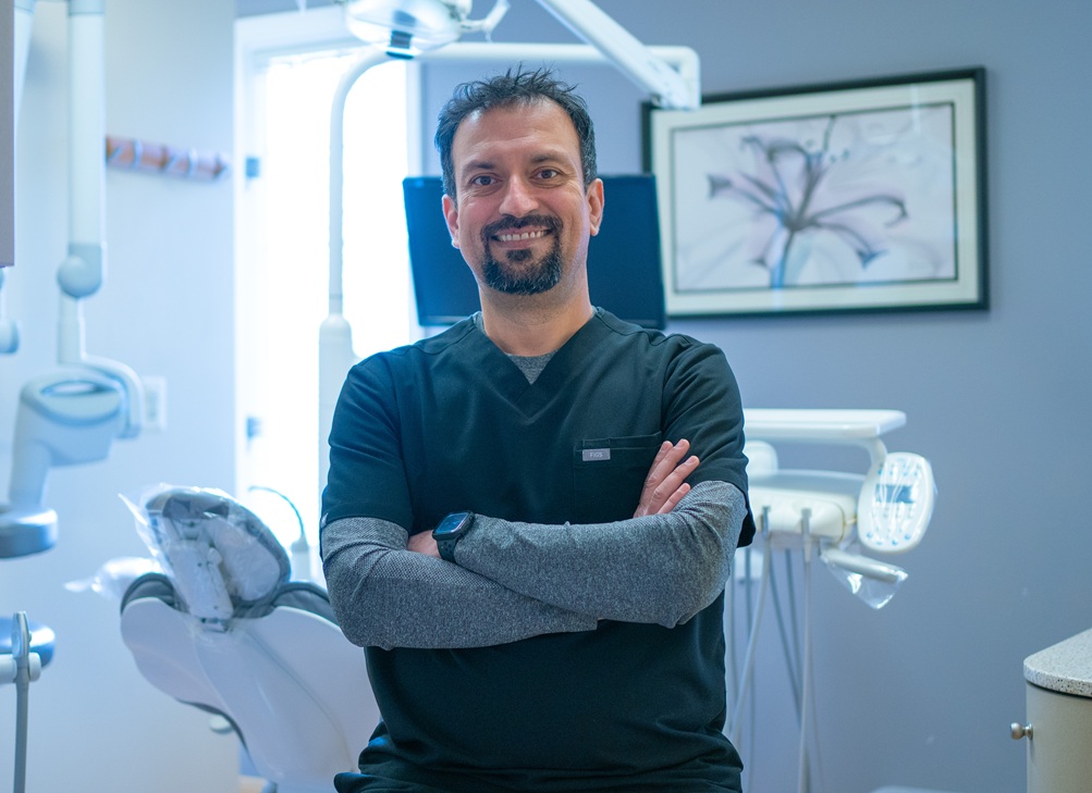 Experienced dentist smiling in a modern dental office in Reston, VA