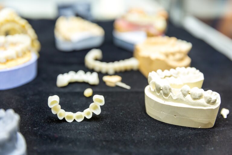 Dentist showing a dental bridge model to a patient at Reston Serenity Smiles in Reston, VA